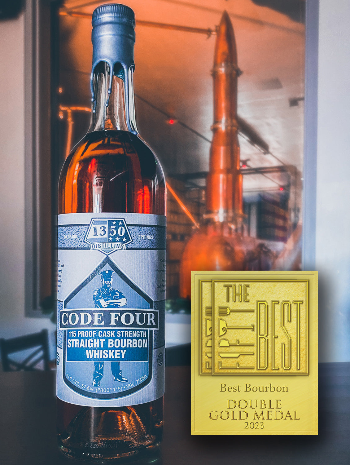 Double Gold Medal for The Fifty Best Bourbon 2023 sits to the left of a round bottle with gray label in front of the "rocket still" in background. Hand-dipped silver wax drapes over the cork and neck of the bottle. An illustration of a police officer standing with arms crossed is behind the words “Code Four 115 Proof Cask Strength Straight Bourbon Whiskey”. The 1350 Distilling logo is centered at the top label.