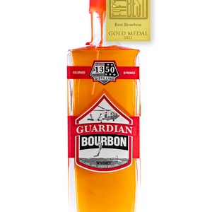 Gold Medal for The Fifty Best Bourbon of 2023 sits over a rectangular tall bottle with two U.S. Coast Guard orange labels spanning across all sides of the bottle with a white background. Hand-dipped U.S. Coast Guard orange wax drapes over the cork and neck of the bottle. An illustration of a U.S.C.G. Sikorsky helicopter with a search and rescue diver jumping into water is behind the words “Guardian Bourbon”. The 1350 Distilling logo is centered at the top label.